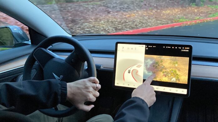 Tesla released an over-the-air software update that allows the driver to play video games while driving, which raises huge safety concerns.